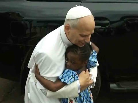 Young girl runs to hug Pope after his mass in conflict-hit northwest Cameroon
