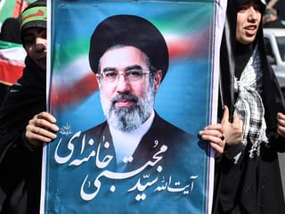 An Iranian woman holds up an image of Iran’s new supreme leader Ayatollah Mojtaba Khamenei as she takes part in a rally dubbed “Sacrificed Girls” to pay tribute to women killed during the Middle East war, in Tehran on April 17, 2026.