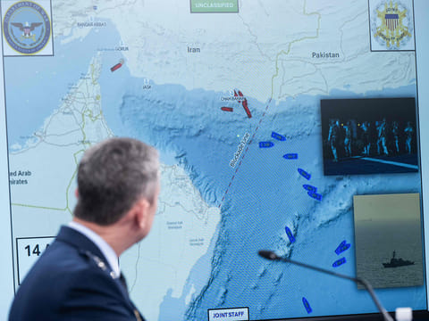 US Chairman of the Joint Chiefs of Staff General Dan Caine speaks as a map of the Strait of Hormuz is displayed during a press briefing at the Pentagon in Washington, DC, on April 16, 2026. 