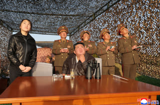 In this photo provided by the North Korean government, its leader Kim Jong Un, sitting, with his daughter observes what it says a test launch of an upgraded surface-to-surface ballistic missile at an undisclosed place in North Korea Sunday, April 19, 2026. Independent journalists were not given access to cover the event depicted in this image distributed by the North Korean government. The content of this image is as provided and cannot be independently verified. Korean language watermark on image as provided by source reads: "KCNA" which is the abbreviation for Korean Central News Agency. (Korean Central News Agency/Korea News Service via AP)