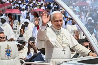 Pope Leo XIV waves to the crowd from the Popemobile as he arrives to lead the Holy Mass at the Saurimo esplanade in Saurimo on the eighth day of an 11-day apostolic journey to Africa, on April 20, 2026.