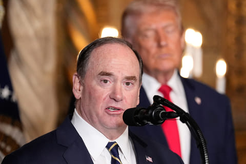  Secretary of the Navy John Phelan speaks, as President Donald Trump listens, at Trump's Mar-a-Lago club, Dec. 22, 2025, in Palm Beach, Fla. 