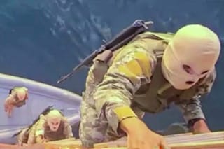 This screen grab from video released by Iran’s Revolutionary Guards (IRGC) and aired by state broadcaster IRIB on April 23, 2026, allegedly shows IRGC naval forces boarding a ship in the Strait of Hormuz.