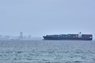 A container ship is seen in the Strait of Hormuz off the coast of Qeshm Island, Iran, Saturday, April 18, 2026.