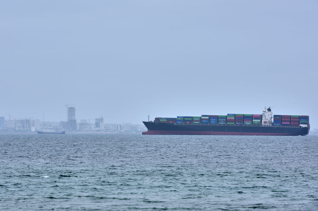 A container ship is seen in the Strait of Hormuz off the coast of Qeshm Island, Iran, Saturday, April 18, 2026.