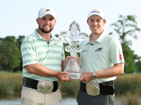 Alex Fitzpatrick (L) of England and Matt Fitzpatrick of England pose with the trophy on the 18th green after winning the Zurich Classic of New Orleans 2026 at TPC Louisiana