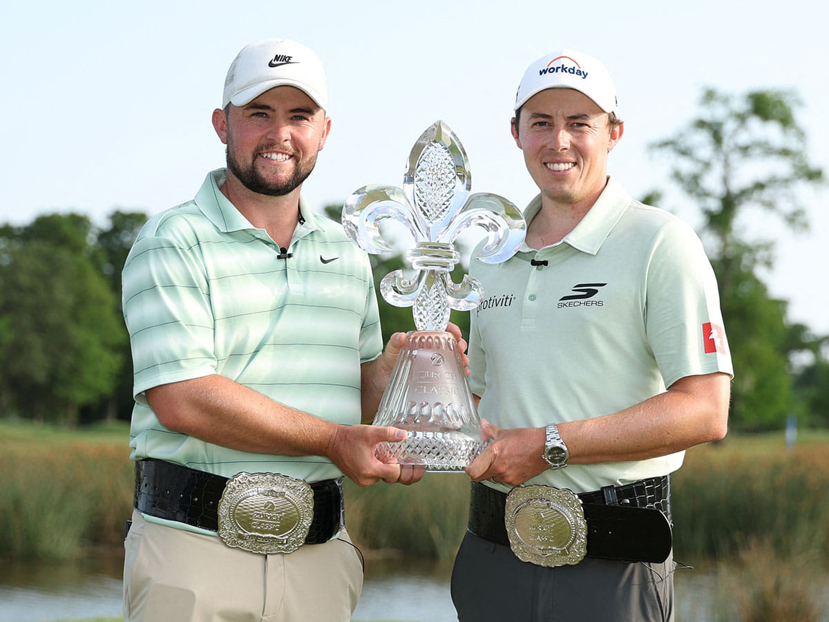 Alex Fitzpatrick (L) of England and Matt Fitzpatrick of England pose with the trophy on the 18th green after winning the Zurich Classic of New Orleans 2026 at TPC Louisiana