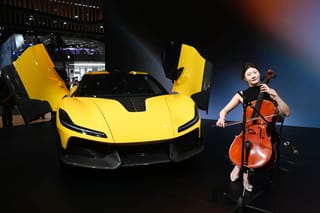 China’s top automakers unveil cutting-edge models and technology at the Beijing Auto Show, highlighting advances in intelligent driving, ultrafast charging, and electric vehicles. More than 1,450 vehicles are on display, including 181 global debuts. Above, a musician plays next to a Dreame Nebula Next 01 concept car at the Beijing Auto Show in Beijing.