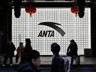 People walk past an Anta store in the Huangpu district of Shanghai 