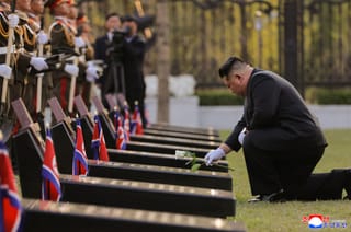 This picture taken on April 26, 2026 and released by North Korea's official Korean Central News Agency (KCNA) via KNS on April 27, 2026 shows North Korean leader Kim Jong Un (R) laying a flower at the tombstones of North Korean troops during the inauguration ceremony of the Memorial Museum of Combat Feats at the Overseas Military Operations in Pyongyang.