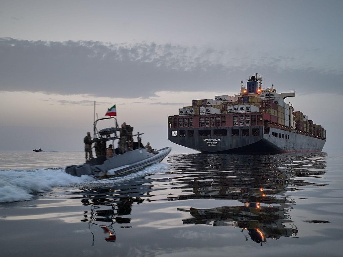 In this photo released by Tasnim News Agency, a Revolutionary Guard Navy (IRGC) speedboat approaches the cargo ship during what state media described as the seizure of one of two vessels accused of violations in the Strait of Hormuz
