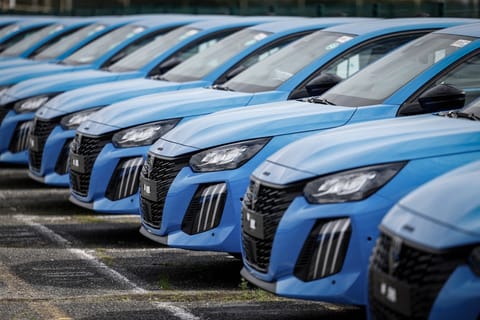 Peugeot cars are seen parked outside the Stellantis multinational car manufacturer's plant in Poissy, west of Paris, on April 15, 2026.