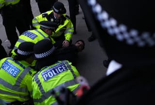 Police arrest a demonstrator during a rally organised by the Campaign Against Antisemitism, opposite Downing Street in central London on April 30, 2026, following the stabbing of two Jewish men the day before in the Golders Green neighbourhood of north London.