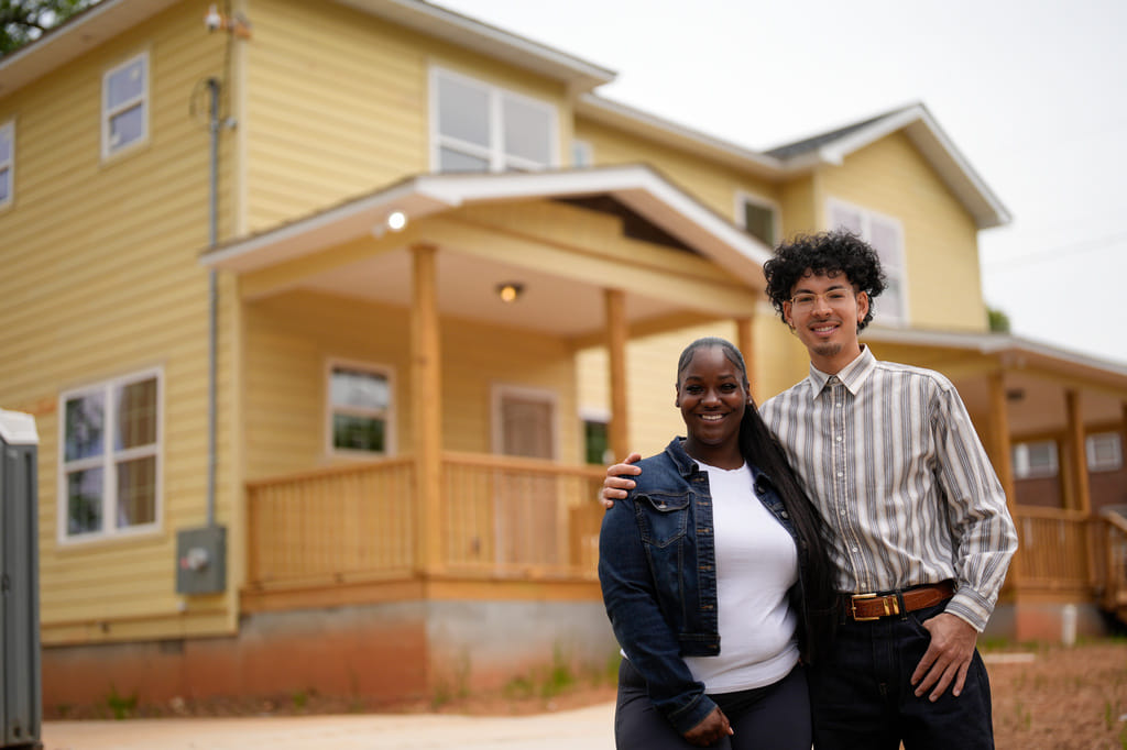 Home owners Phileena Daniel and Oswaldo Herrera pose for a photo in Langston Park, April 13, 2026, in Atlanta. (AP Photo/Mike Stewart)