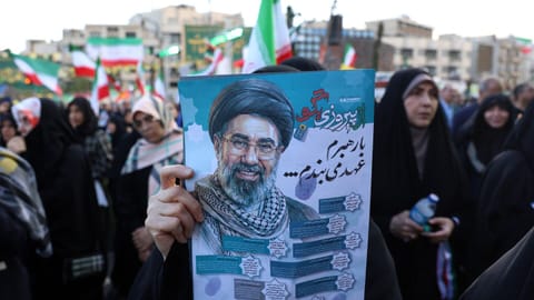A woman holds a poster of Iranian Supreme Leader Ayatollah Mojataba Khamenei during a rally in Tehran on April 29, 2026.