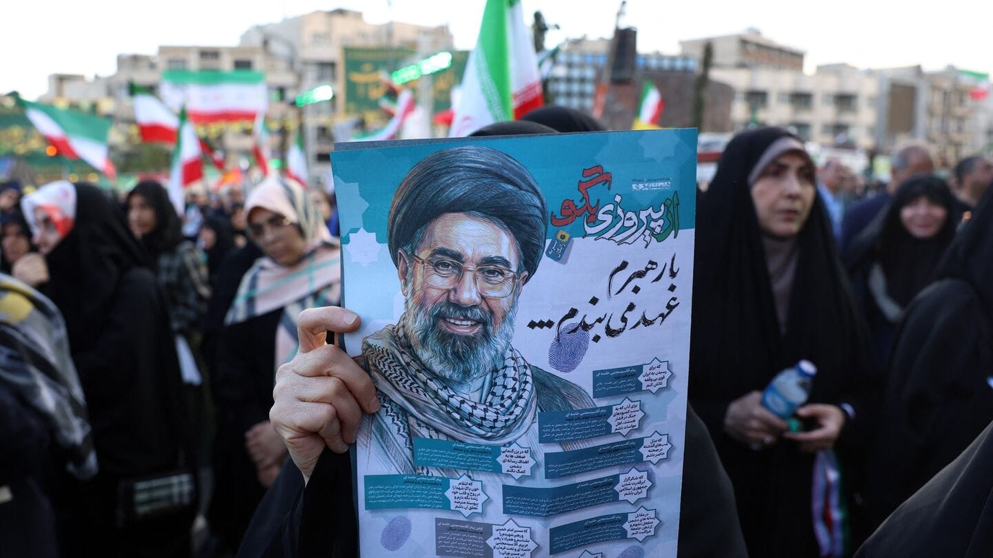 A woman holds a poster of Iranian Supreme Leader Ayatollah Mojataba Khamenei during a rally in Tehran on April 29, 2026.