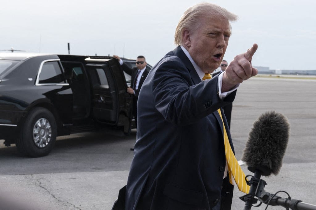 President Donald Trump speaks to journalists before boarding Air Force One at Palm Beach International Airport on May 2, 2026 in Palm Beach, Florida.