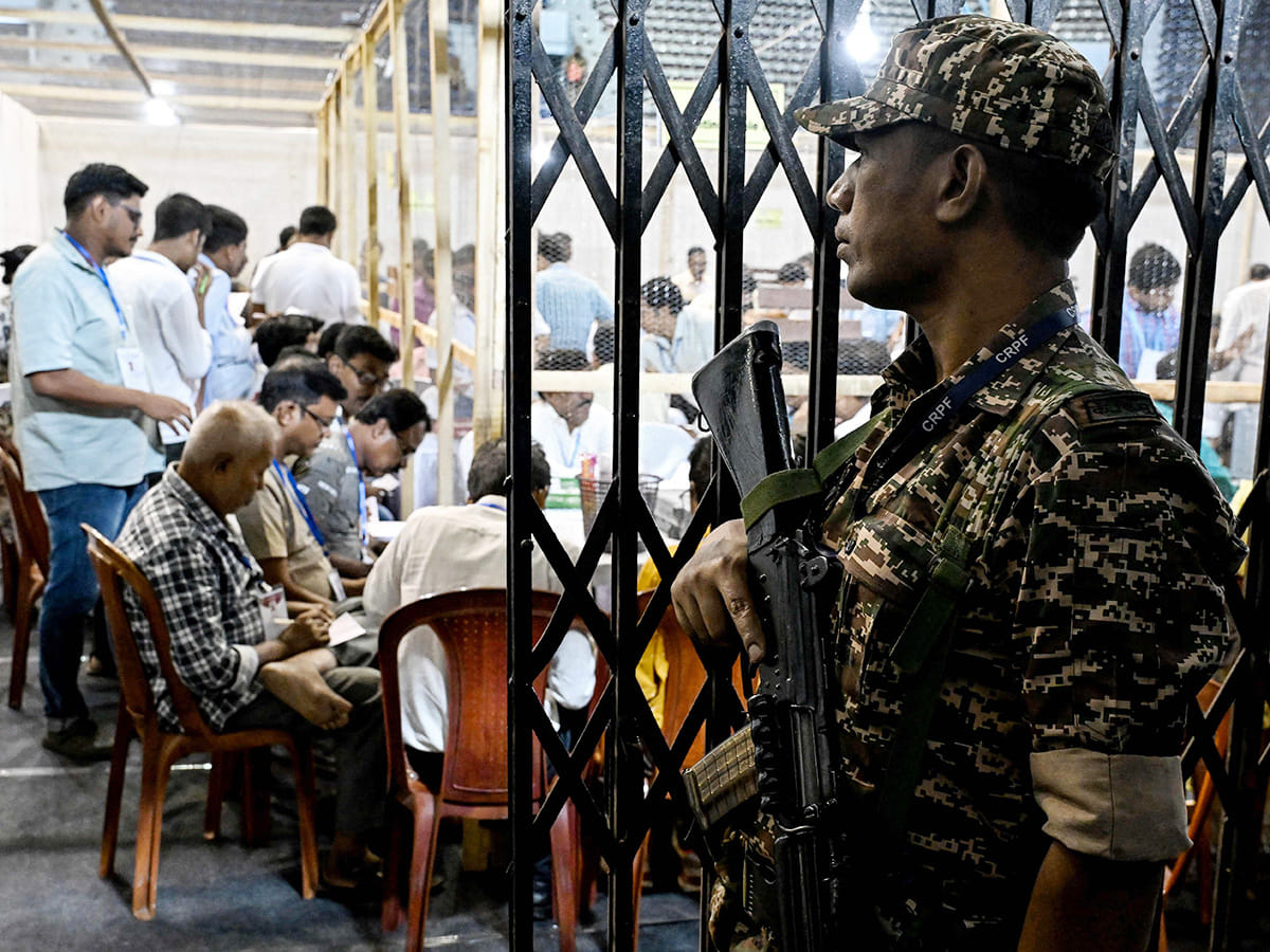 A Central Reserve Police Force (CRPF) personnel stands guard as election officials count votes after the West Bengal Legislative Assembly elections at the Netaji Indoor Stadium in Kolkata on May 4, 2026. 