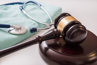 12 doctors and nurses referred to an urgent disciplinary trial over the death of a patient following a series of malpractices. 
