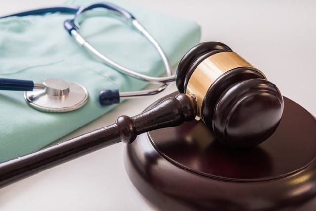 12 doctors and nurses referred to an urgent disciplinary trial over the death of a patient following a series of malpractices. 