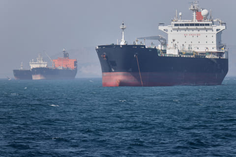Oil tankers sit at anchor offshore in the Strait of Hormuz off Bandar Abbas, Iran, Saturday, May 2, 2026. (Amirhosein Khorgooi/ISNA via AP)