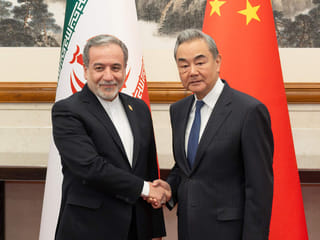 Iranian Foreign Minister Abbas Araghchi, left, is greeted by his Chinese counterpart Wang Yi prior to their bilateral meeting in Beijing.