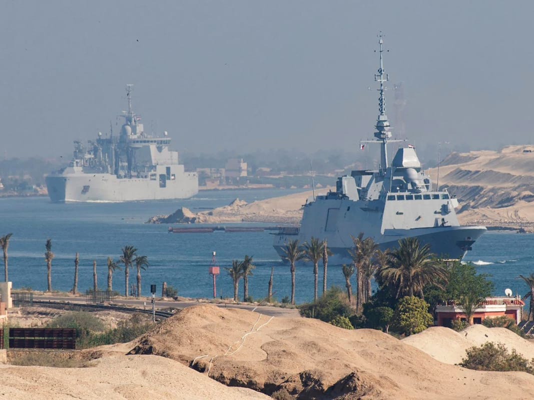 The French Navy's Carrier Strike Group that includes the flagship aircraft carrier Charles de Gaulle (unseen) and its escort transiting the Suez Canal en route to the southern Red Sea to pre‑position for a possible mission to restore navigation in the Strait of Hormuz.