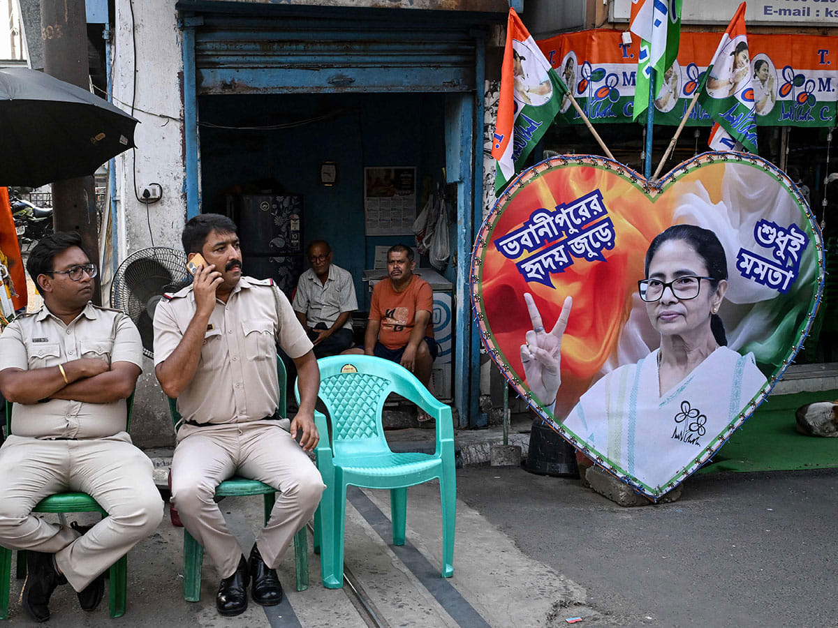 Police personnel guard the road leading towards the residence of West Bengal Chief Minister and All India Trinamool Congress (TMC) party chairperson Mamata Banerjee in Kolkata on May 5, 2026 after her party lost the recently concluded state legislative assembly elections. 