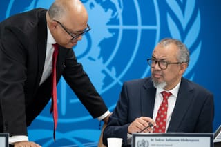This handhout photograph taken and released on May 7, 2026 by the World Health Organization (WHO) shows its Director-General Tedros Adhanom Ghebreyesus (R) speaking with WHO Health Emergencies Programme executive director Chikwe Ihekweazu prior to a virtual press conference on the hantavirus cluster linked to a cruise ship travel, at the WHO headquarters, in Geneva.