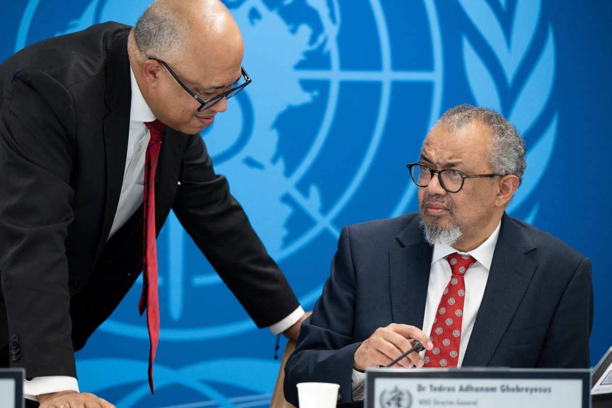 This handhout photograph taken and released on May 7, 2026 by the World Health Organization (WHO) shows its Director-General Tedros Adhanom Ghebreyesus (R) speaking with WHO Health Emergencies Programme executive director Chikwe Ihekweazu prior to a virtual press conference on the hantavirus cluster linked to a cruise ship travel, at the WHO headquarters, in Geneva.