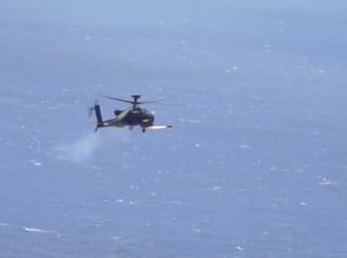 An Apache attack helicopter fires a "Hellfire" missile. On Monday, the US military said it destroyed six small boats in Hormuz area and intercepted Iranian cruise missiles and drones as Tehran sought to impose its toll system over the strait.
