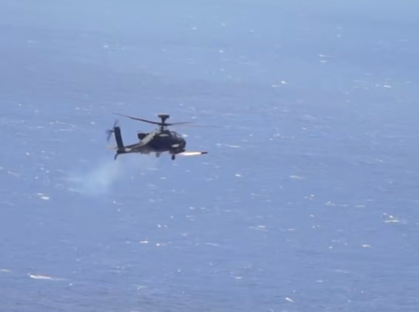 An Apache attack helicopter fires a "Hellfire" missile. On Monday, the US military said it destroyed six small boats in Hormuz area and intercepted Iranian cruise missiles and drones as Tehran sought to impose its toll system over the strait.