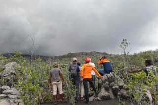 A handout picture taken and released on May 8, 2026 by Indonesia's National Search and Rescue Agency (BASARNAS) shows rescue workers standing by after the volcanic eruption of Mount Dukono in North Halmahera, North Maluku.