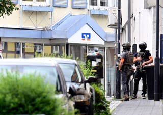 Police stand in front of a bank, where bank robbers have taken multiple hostages in Sinzig, western Germany on May 8, 2026.