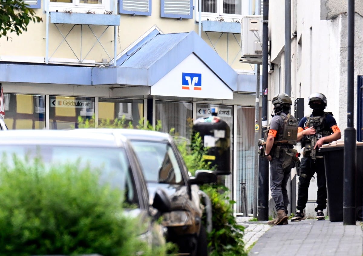 Police stand in front of a bank, where bank robbers have taken multiple hostages in Sinzig, western Germany on May 8, 2026.