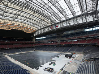 Workers install the first layer of the new playing surface at Houston Stadium, on Friday, May 8, 2026, in Houston, ahead of the 2026 FIFA World Cup soccer matches. 