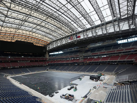 Workers install the first layer of the new playing surface at Houston Stadium, on Friday, May 8, 2026, in Houston, ahead of the 2026 FIFA World Cup soccer matches. 