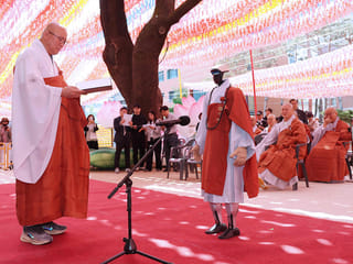 Gabi (R), a humanoid robot dressed as a Buddhist monk, attends an ordination ceremony as part of celebrations for the upcoming Buddha's birthday at Jogye Temple in Seoul. 