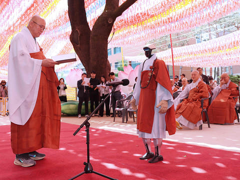 Gabi (R), a humanoid robot dressed as a Buddhist monk, attends an ordination ceremony as part of celebrations for the upcoming Buddha's birthday at Jogye Temple in Seoul. 