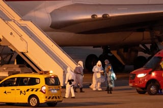 Passengers board a plane bound for US carrying passengers evacuated from the Dutch flagged hantavirus-stricken cruise ship MV Hondius at the Tenerife Sur-Reina Sofia airport on the island of Tenerife in Spain's Canary Islands on May 10, 2026.