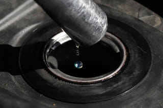 FILE - Gasoline drops from the nozzle of a fuel pump as it fills a motorcycle as prices continue to rise at a gasoline station in Quezon City, Philippines on March 19, 2026. (AP Photo/Aaron Favila, File)