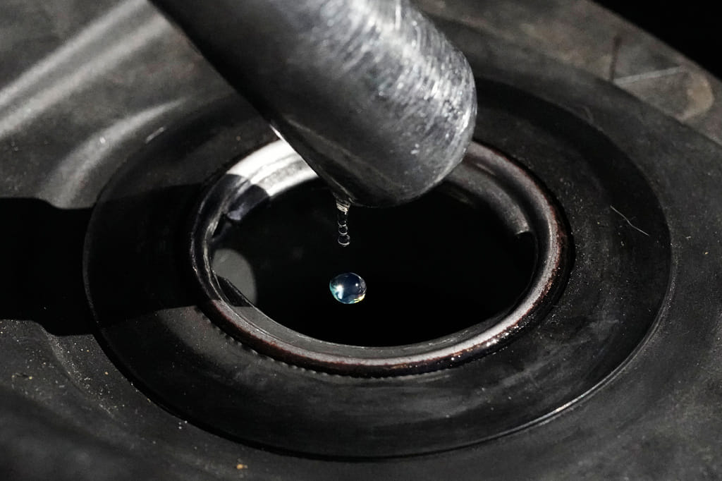 FILE - Gasoline drops from the nozzle of a fuel pump as it fills a motorcycle as prices continue to rise at a gasoline station in Quezon City, Philippines on March 19, 2026. (AP Photo/Aaron Favila, File)
