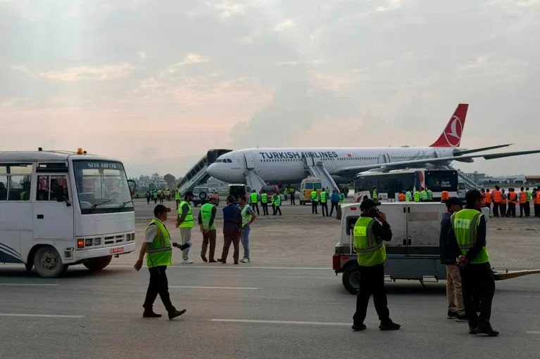 A Turkish Airlines aircraft is seen after passengers were safely evacuated following a fire on the jet while landing in Kathmandu.