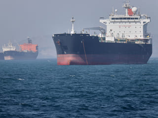 Oil tankers sit at anchor offshore in the Strait of Hormuz off Bandar Abbas, Iran, Saturday, May 2, 2026. 
