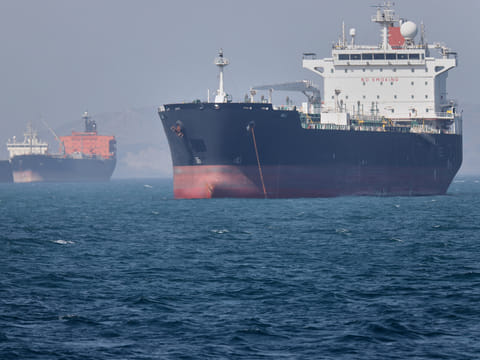 Oil tankers sit at anchor offshore in the Strait of Hormuz off Bandar Abbas, Iran, Saturday, May 2, 2026. 