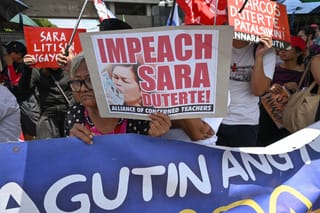 Protesters from progressive groups hold placards during a protest in support of the impeachment of Philippine Vice-President Sara Duterte in front of the Congress building in Quezon City, Metro Manila on May 11, 2026.