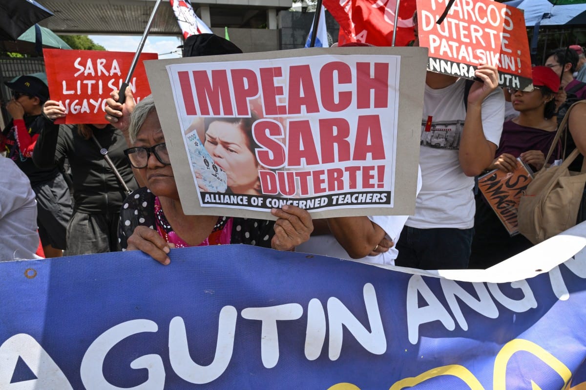 Protesters from progressive groups hold placards during a protest in support of the impeachment of Philippine Vice-President Sara Duterte in front of the Congress building in Quezon City, Metro Manila on May 11, 2026.