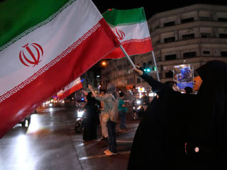 Women hold Iranian flags for a pro-government campaign in downtown Tehran.
