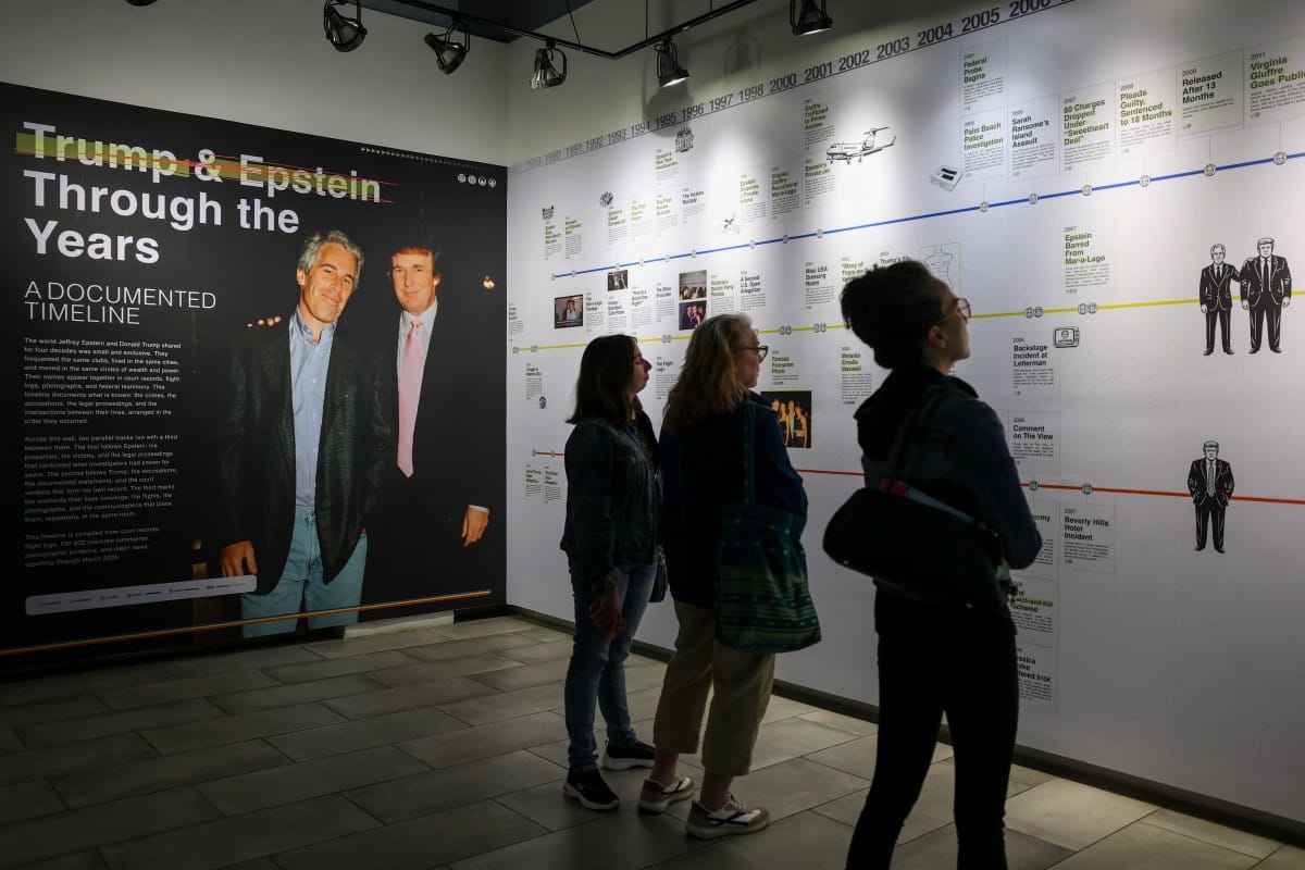 Visitors look at a timeline of events at the “Donald J. Trump and Jeffrey Epstein Memorial Reading Room”, a tribute to the survivors and victims of Epstein's crimes, where 3.5 million pages, 3,437 bound volumes of the Epstein files are displayed in New York City on May 11, 2026.