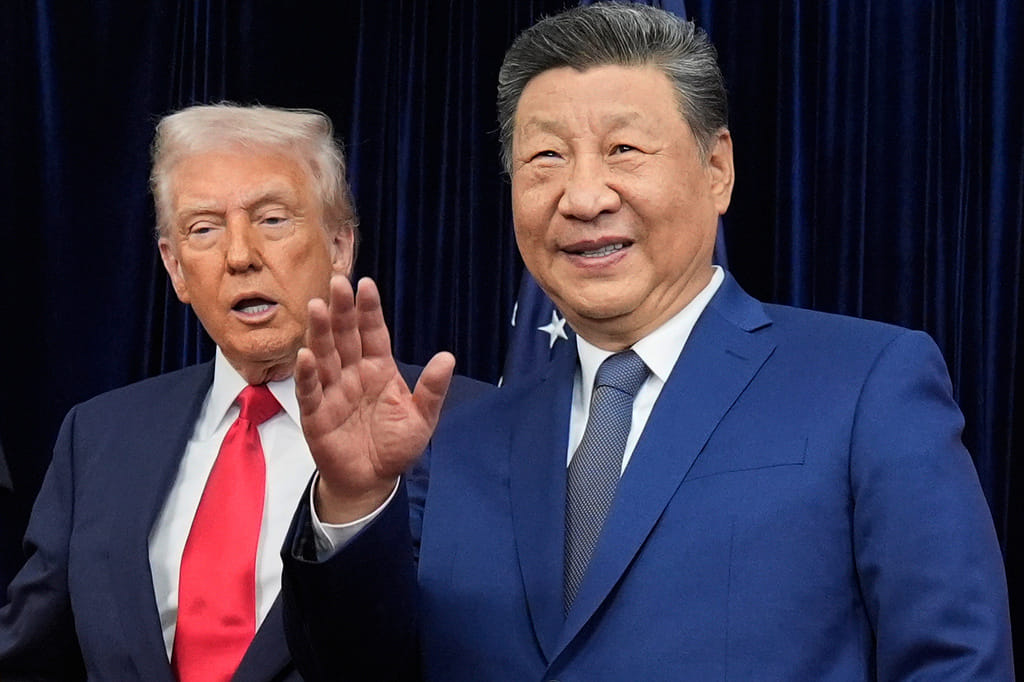 Chinese President Xi Jinping, right, waves, with President Donald Trump, ahead of their summit talk at Gimhae International Airport in Busan, South Korea. File photo taken on Oct. 30, 2025. (AP Photo/Mark Schiefelbein, File)